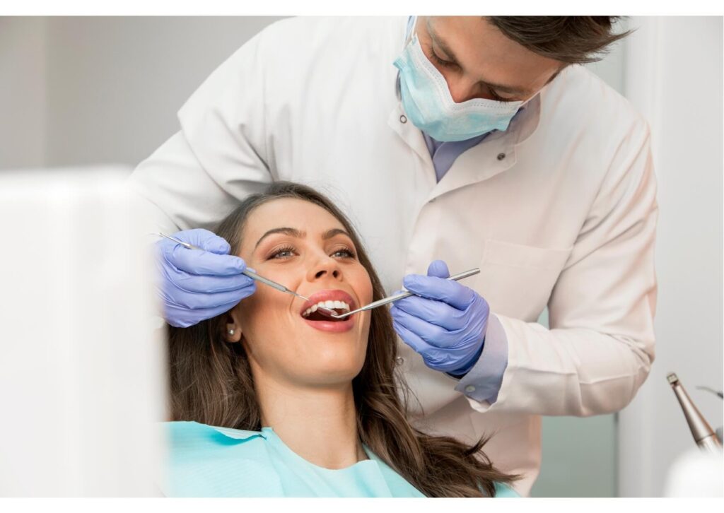 Dentist examining a patient’s teeth during a consultation about dental implant costs and treatment options