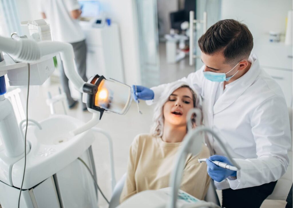 Dentist discussing professional teeth whitening options with a patient during a cosmetic dental consultation.