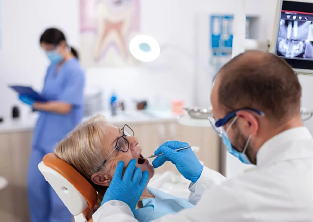 Dentist examining a patient while discussing the different types of dental implants available for replacing missing teeth.