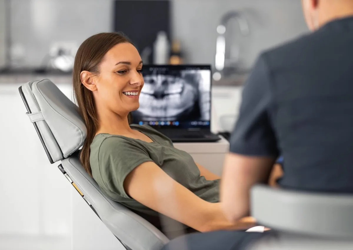 Patient discussing affordable dental implant options with a dentist during a consultation.